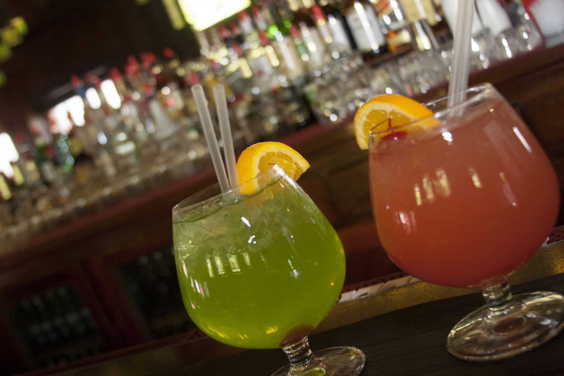 brightly colored cocktails in a cozy bar scene